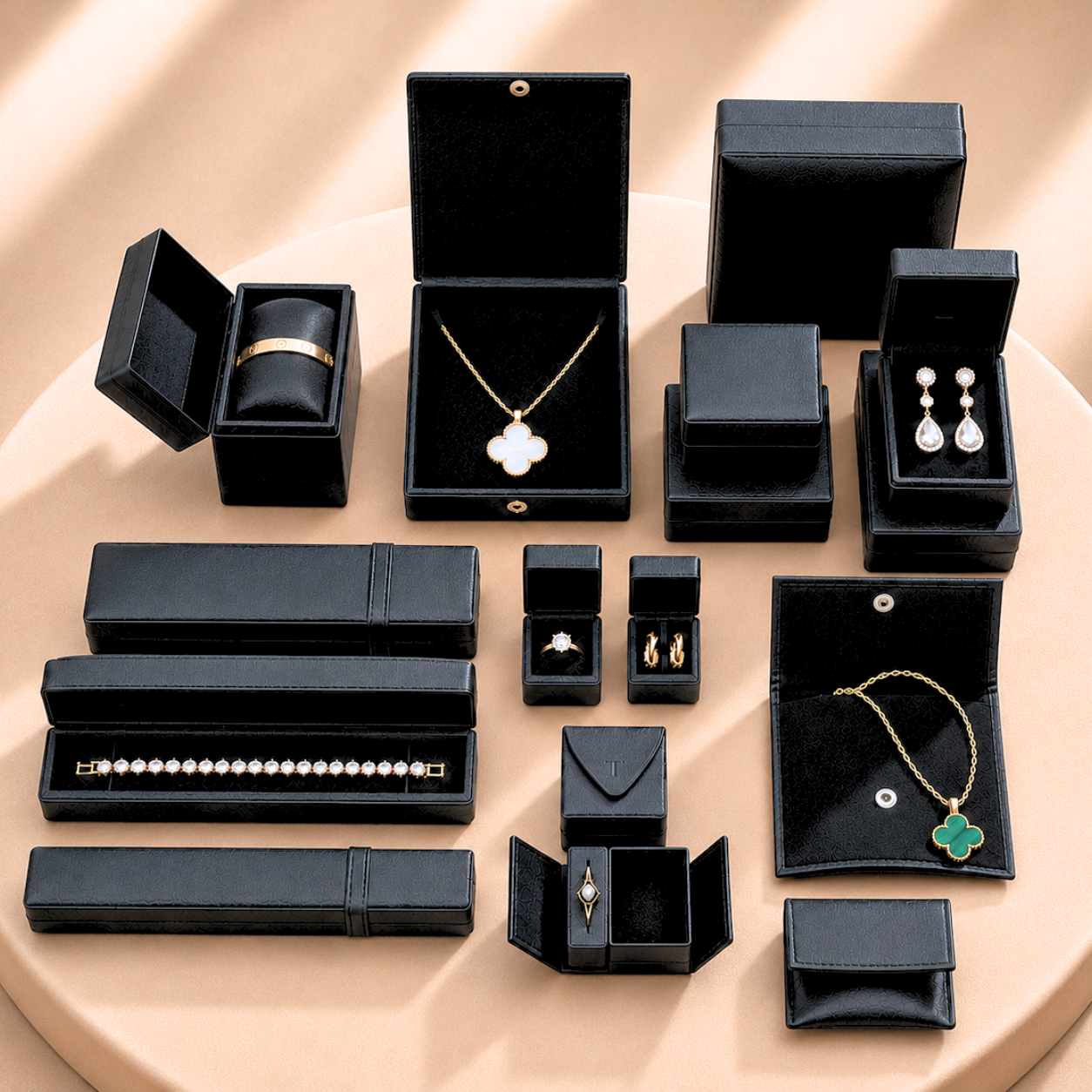 lack jewellery boxes, trays, and pouches in various shapes and sizes. Includes rectangular, square, and cylindrical boxes, some with hinged lids. Display boards and trays offer stylish options for showcasing and storing jewellery.