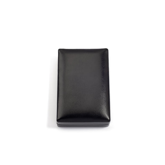 A closed, rectangular black jewelry box with a smooth, shiny surface, placed on a white background.