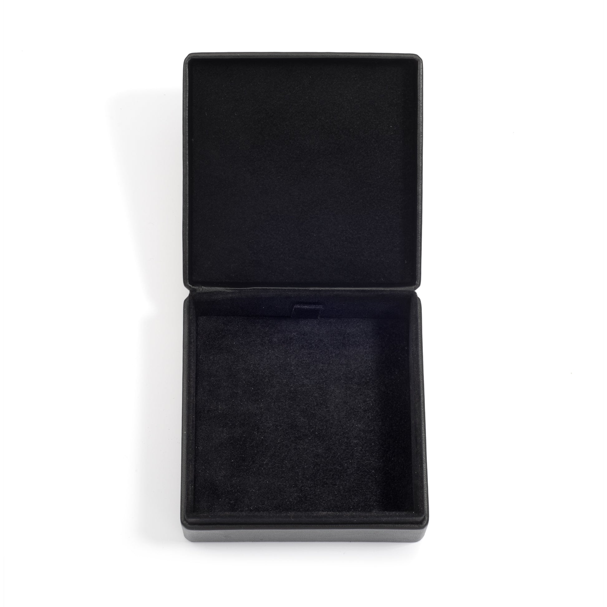 An open, empty black jewellery box with a soft black interior lining, displayed on a white surface.