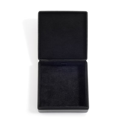 An open, empty black jewellery box with a soft black interior lining, displayed on a white surface.