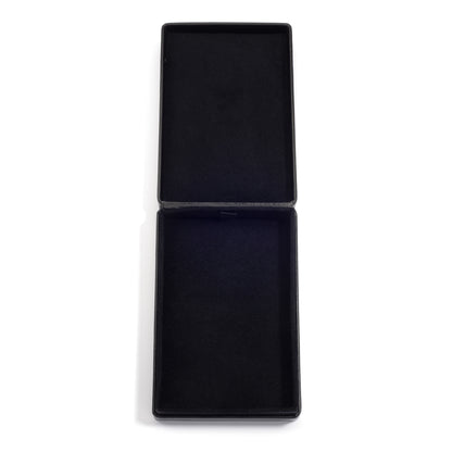 An open, empty black jewelry box with a soft, black interior lining, shown on a white background.
